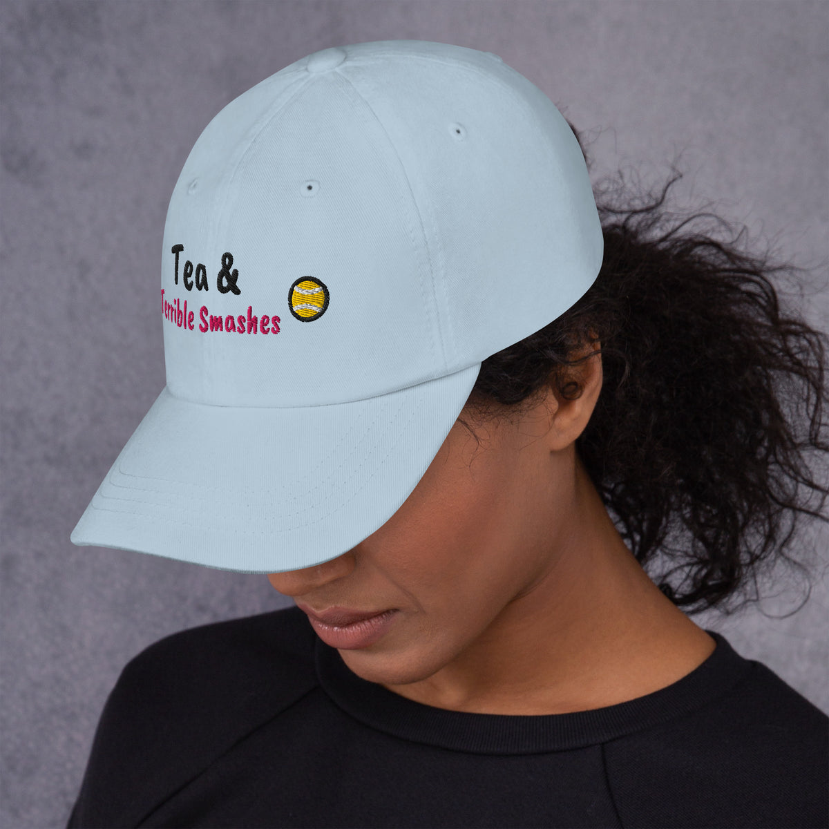 Ocean blue padel dad cap with the Tea & Terrible Smashes design embroidered on the front, left side view