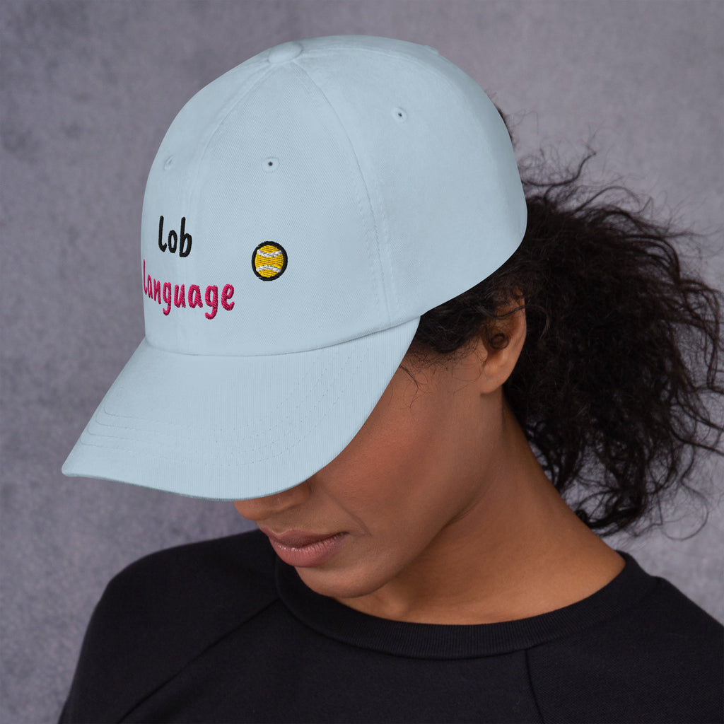 Ocean blue padel dad cap with the Lob Language design embroidered on the front, left side view