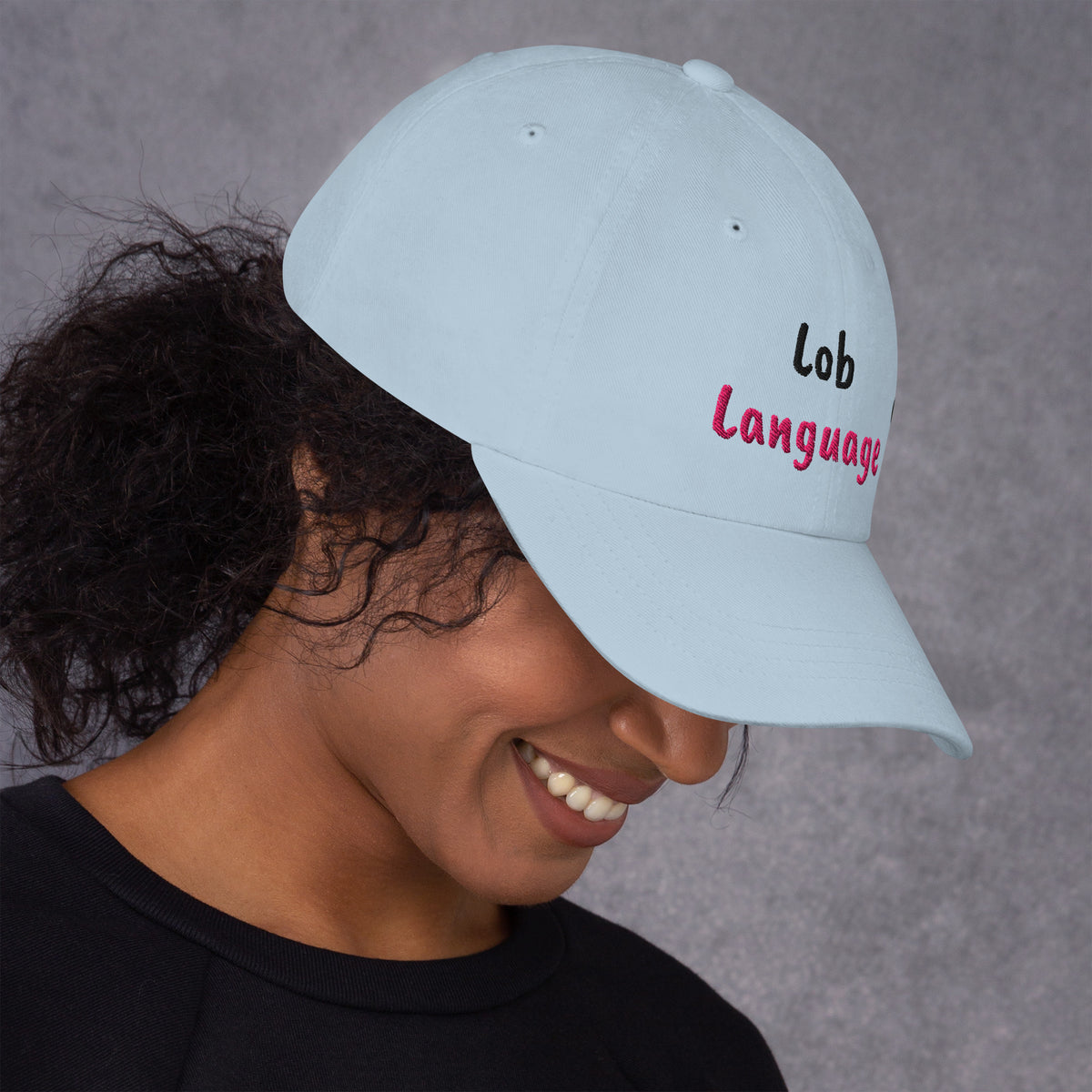 Ocean blue padel dad cap with the Lob Language design embroidered on the front, right side view