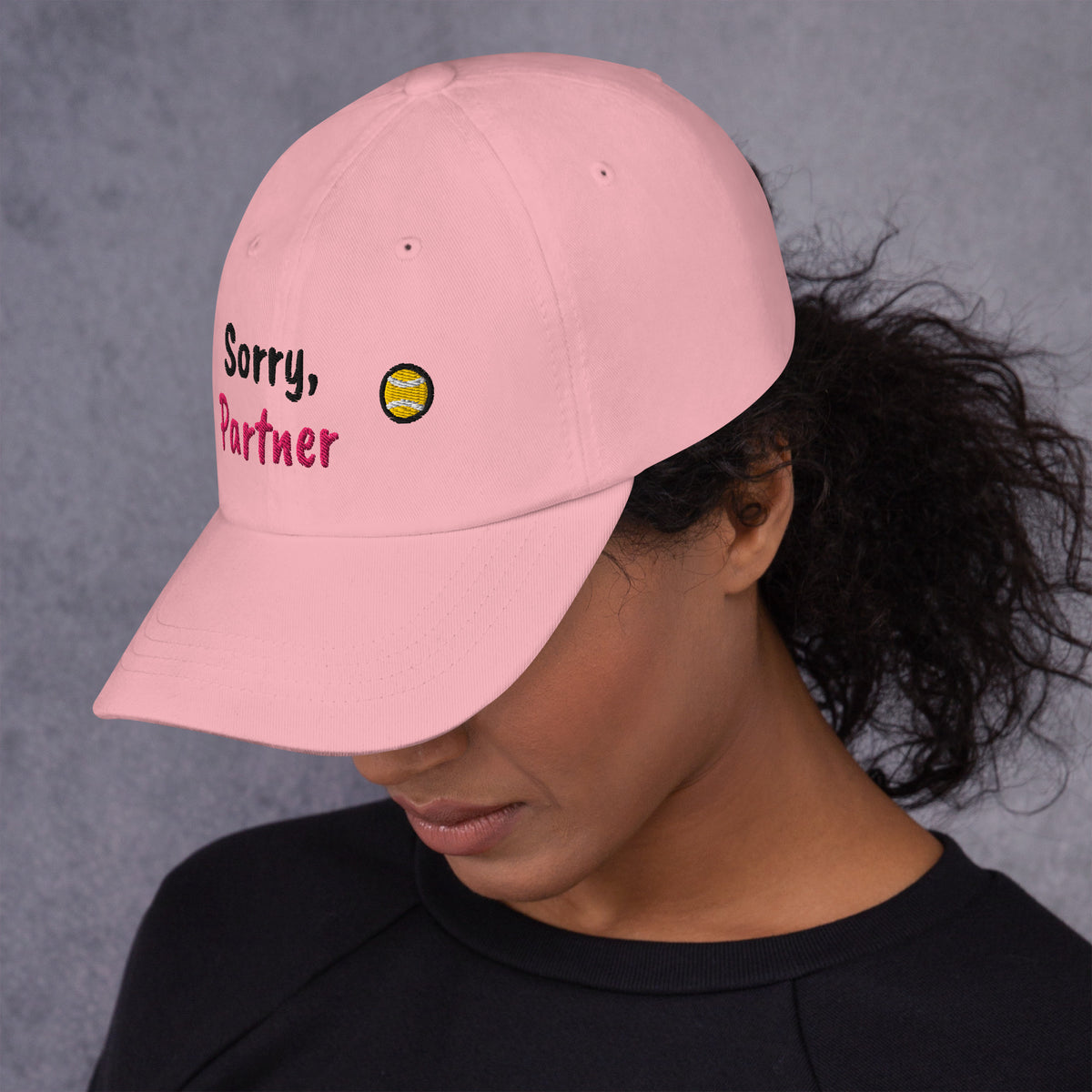 Pink padel dad cap with the Sorry, Partner design embroidered on the front, left side view
