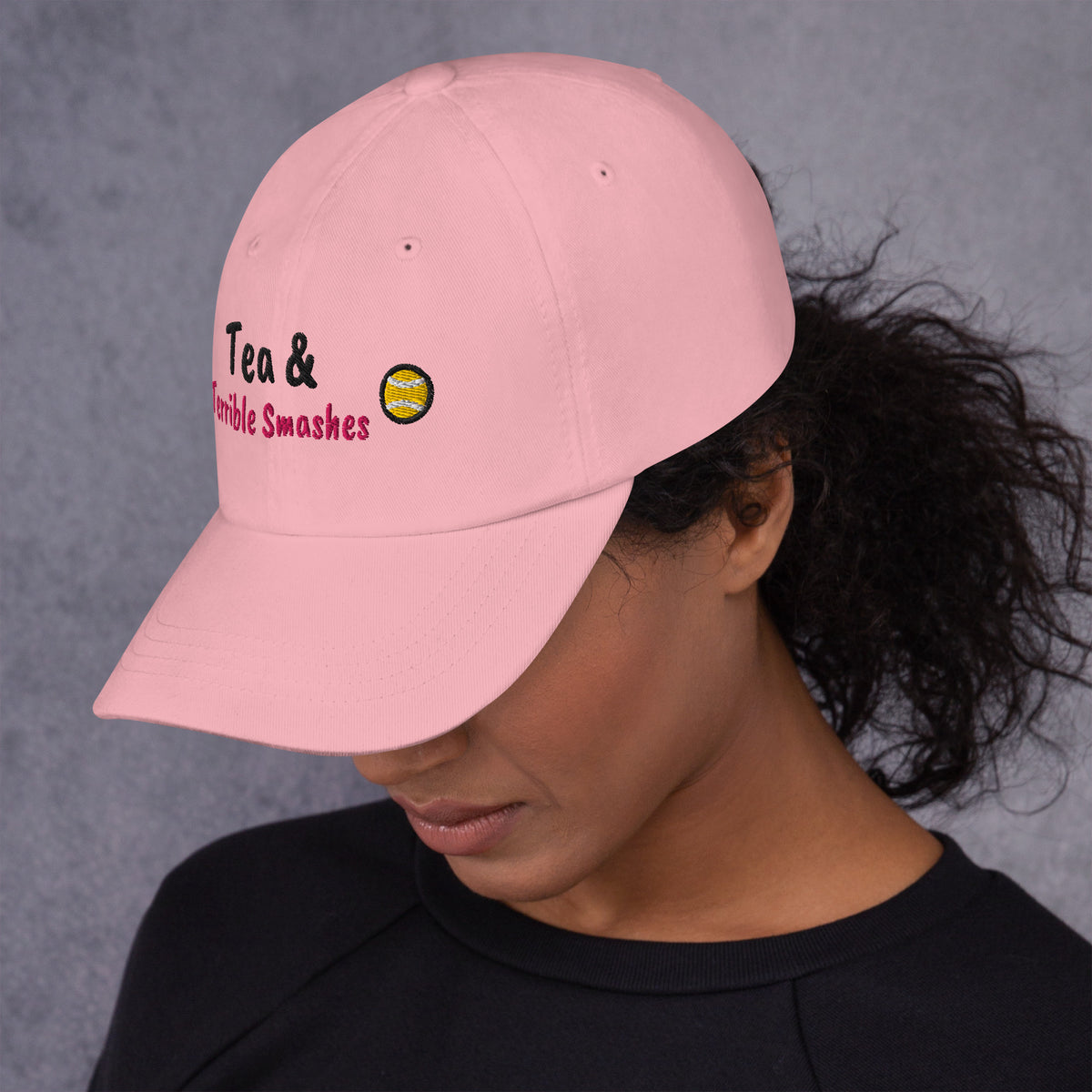Pink padel dad cap with the Tea & Terrible Smashes design embroidered on the front, left side view