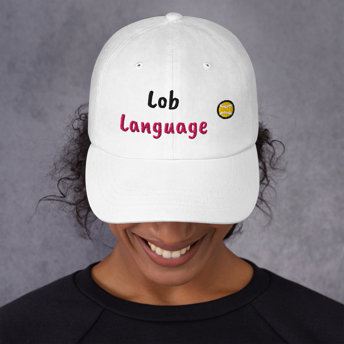 White padel dad cap with the Lob Language design embroidered on the front, front view
