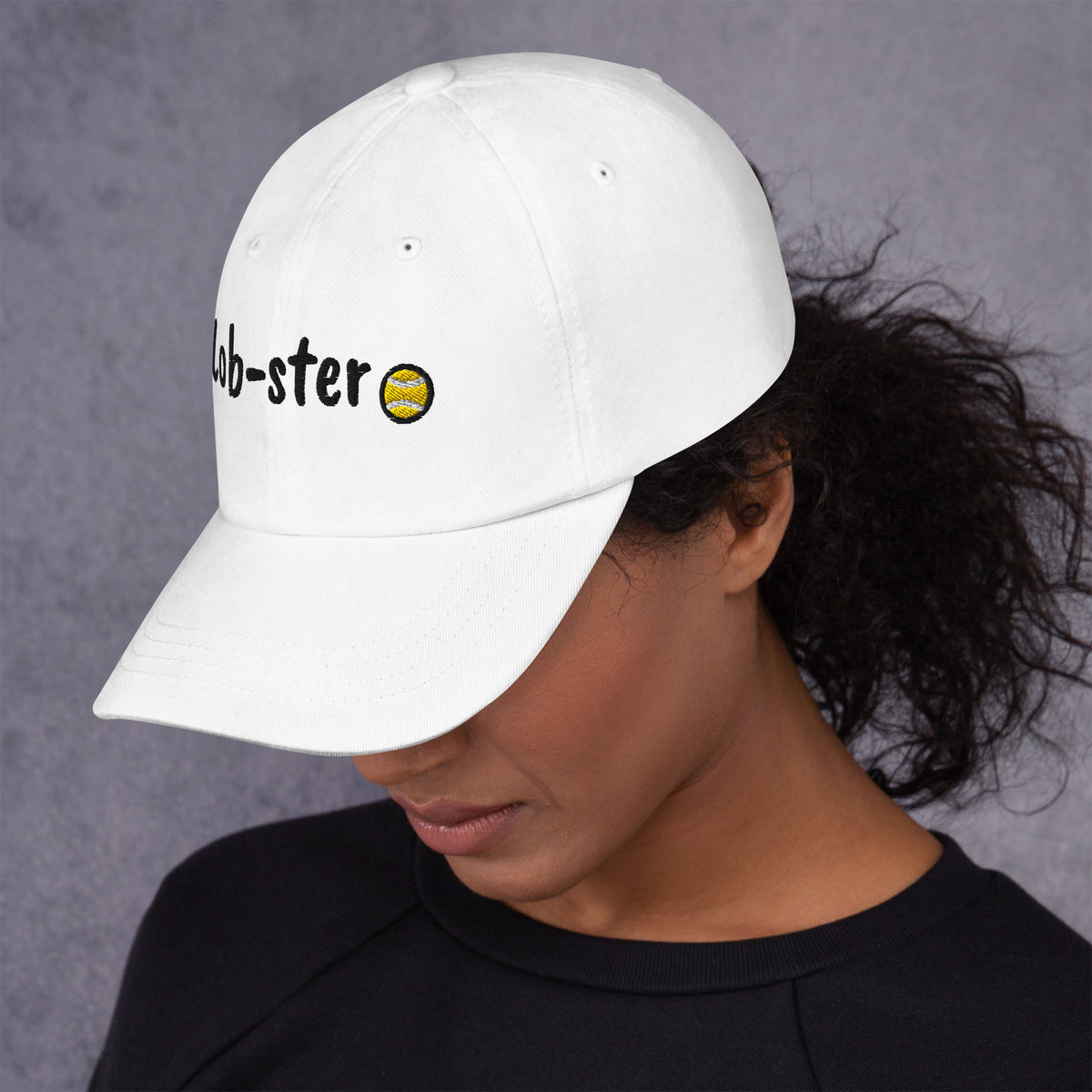 White padel dad cap with the Lob-ster design embroidered on the front, left side view