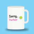White 11 oz padel mug with the slogan “Sorry, Partner”